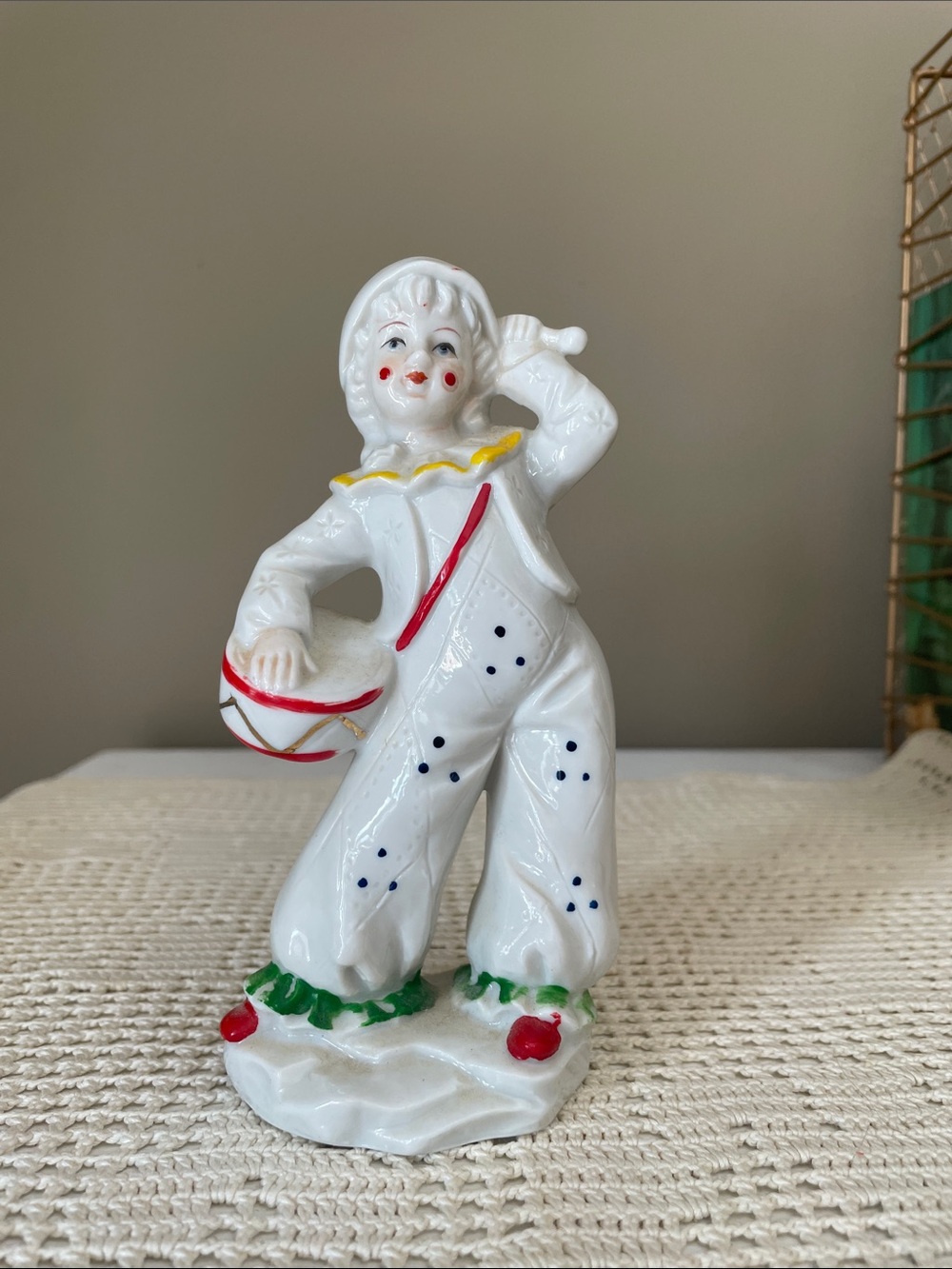 Porcelain clown figurine playing a drum